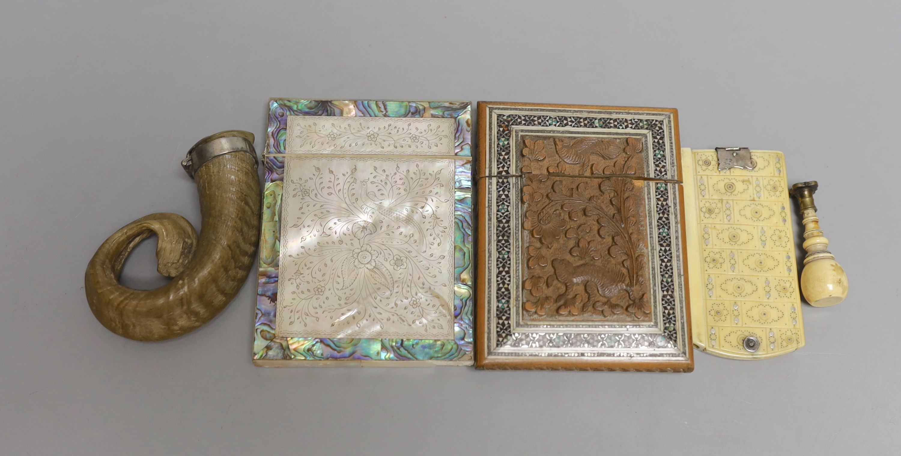 A Victorian mother-of-pearl and abalone card case, a Southern Indian card case, an ivory and pique work aide memoir, a mounted Rams-horn snuff mull and an ivory handled seal, Snuff mull 8.5 cms wide.